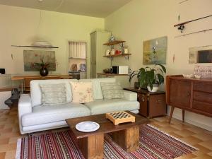 a living room with a white couch and a table at The olive tree vacation home in Colico in Colico