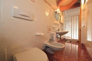 a bathroom with a toilet and a sink at Villa Marta in Mazzin +30 photos