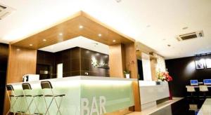 a bar in a restaurant with chairs around it at Starz Hotel in Kluang