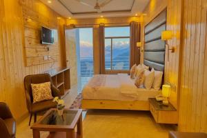 a hotel room with a bed and a balcony at Hotel Lily Woods, Near JW Marriott Mussoorie - A Beautiful Lavish & Luxury Hotel with Mountain View Managed By Lily in Mussoorie