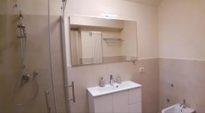 a bathroom with a sink and a shower with a mirror at Corte Trambai in Gambellara +22 photos