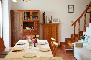 a living room with a table and a couch at Casa Furletti Holiday Home in Tenno