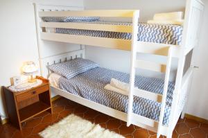 a bedroom with bunk beds and a rug at Casa Furletti Holiday Home in Tenno