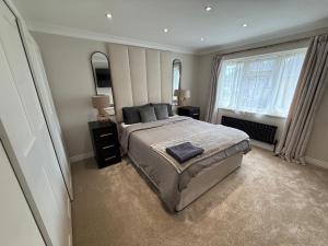 een slaapkamer met een groot bed en twee ramen bij 3 bedroom house Hildenborough in Hildenborough