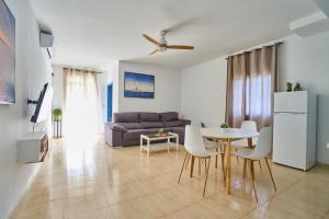 a living room with a couch and a table and chairs at Apartamentos Venta Lanuza, El Campello in El Campello