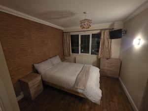 a small bedroom with a bed and a window at The Nook in Taunton