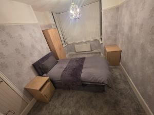 a small bedroom with a bed and a chandelier at The Nook in Taunton +6 photos