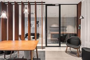 a dining room with a table and chairs and a piano at City Break Śląska 8 by INA in Gdańsk +111 photos