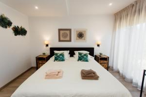 a bedroom with a large white bed with towels on it at Hotel Boutique Canelobre in Busot +143 photos