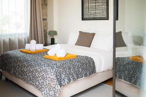 a bedroom with a bed with two towels on it at Oakstone Hills in Nelas