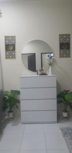 a bathroom with a mirror and a white dresser at REZEKI MUEZZA 3BR2B Cozy Homestay in Teluk Intan