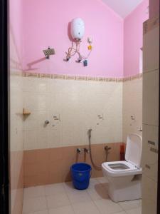 a bathroom with a toilet and a camera on the wall at Dream House Near IIM Kozhikode & NIT Calicut in Kozhikode
