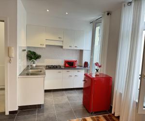 a kitchen with a red refrigerator and a sink at Sweet Dream House in Brussels +4 photos