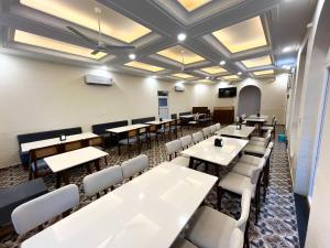 a dining room with white tables and white chairs at Muchaan Resort in Gochar +10 photos
