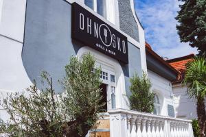 a sign on the side of a white house at Penzion Ohnysko in Trnava