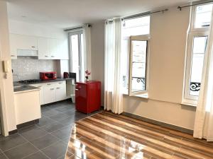 a kitchen with a red refrigerator in a room with windows at Sweet Dream House in Brussels