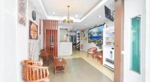 a living room with chairs and a dining room at OYO 91052 Hotel Kenangan in Kuala Terengganu