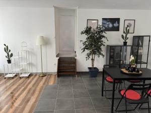 a living room with a black table and chairs at Sweet Dream House in Brussels