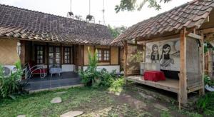 Una casa con una pintura en el costado. en Hotel O Putroyono Homestay, en Mendut