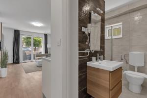 a bathroom with a white sink and a toilet at Villa Jasna - Makarska Exklusiv in Tučepi +135 photos