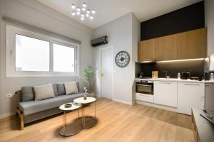 a living room with a couch and a table at Iconic Location Aristotelous Tsimiski in Thessaloniki