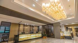 a hotel lobby with a reception desk and a chandelier at The Plaza Lodge Baguio in Camp John Hay +142 photos