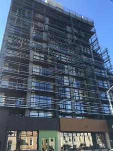 a tall building with scaffolding on the side of it at Boro Hotel in Queens