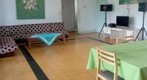 a living room with a couch and a table and chairs at SURGA DIRGA RESORT in Puncak +65 photos