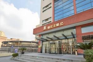 a building with a sign on the front of it at Jinjiang Inn Select Shanghai Fengxian Baolong Square North Yunhe Road in Fengxian