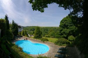 a beach with a pool and a pool table at Commonwood Manor in East Looe