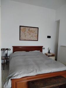 a bed in a bedroom with a map on the wall at Casa Roberta in Pacentro