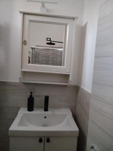 a bathroom with a white sink and a window at Casa Roberta in Pacentro +17 photos