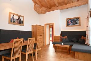 a living room with a couch and a table at Apartment Zugspitze in Biberwier