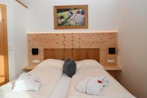 a bedroom with two beds with white sheets at Apartment Zugspitze in Biberwier