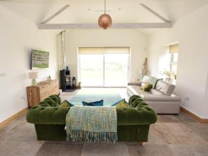 a living room with a green couch in a room at 3 Bed in Belford oc-cn065 in Belford