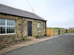 a stone house with a black door and a driveway at 3 Bed in Belford oc-cn065 in Belford