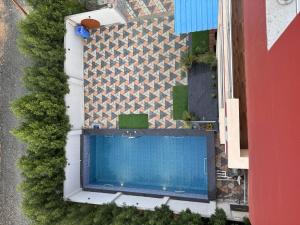an overhead view of a swimming pool next to a building at Silver Green Resort in Gumgaon