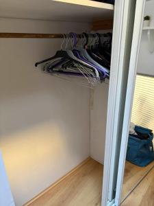 a closet with a bunch of clothes in it at Charmant T2 en duplex in Bordeaux