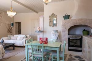 a living room with a table and chairs and a fireplace at Hermia Mansion in Ermoupoli