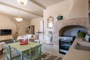 a kitchen and living room with a stone fireplace at Hermia Mansion in Ermoupoli