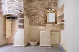 a bathroom with a sink and a mirror at Hermia Mansion in Ermoupoli +30 photos
