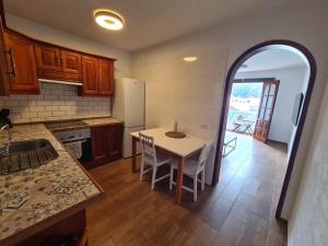a kitchen with a table and a kitchen with a table and chairs at Jurgita Apartment in Los Llanos de Aridane
