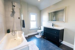 a bathroom with a tub and a sink and a toilet at The Nines in Bangor