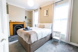 a bedroom with a bed and a fireplace at The Nines in Bangor
