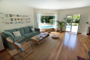 a living room with a couch and a table at Sunny Soul in Malveira da Serra