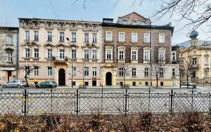 a large building with a fence in front of it at WOW Hostel in Krakow