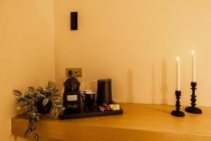 a counter with two candles and a coffee maker on it at Aria Stay in Drama