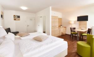 a hotel room with two beds and a table at ante porta DAS STADTHOTEL in Trier