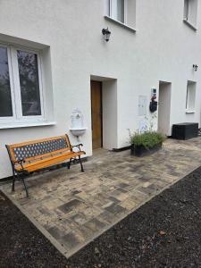 a bench sitting in front of a building at White Haven Private Sauna & Pool in Chřibská