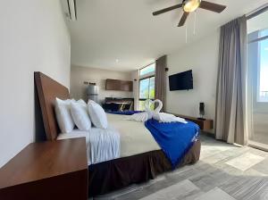 a bedroom with a large bed with a ceiling fan at Hotel Piedra del Caribe Puerto Morelos in Puerto Morelos +93 photos